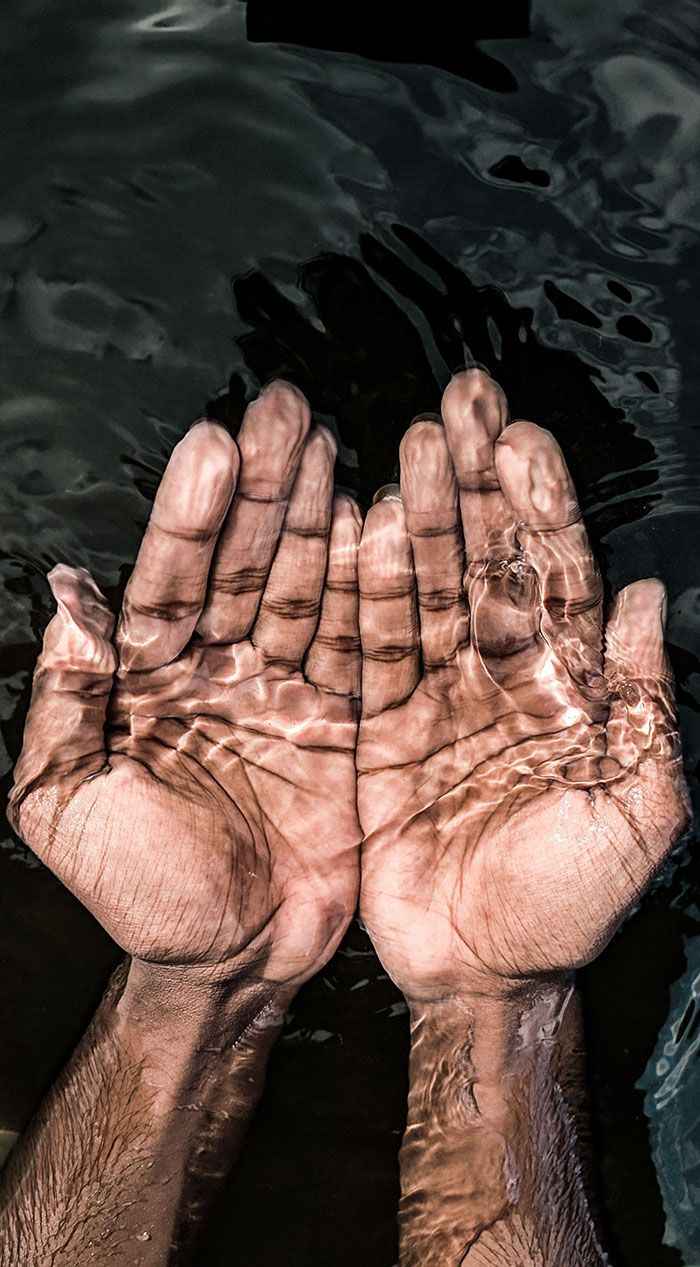 Hands under water